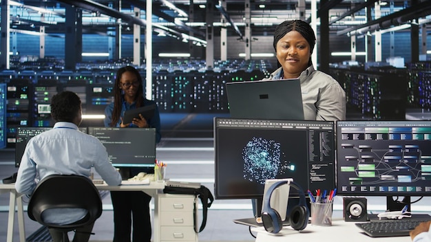 Free Photo cheerful data center employee using node tree software to analyze datasets