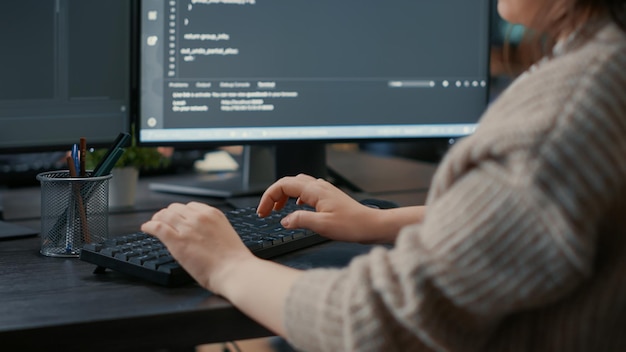 Free Photo closeup of caucasian software coder hands typing on keyboard in front of computer screens with programming interface. database developer sitting at desk writing algorithm for it agency.
