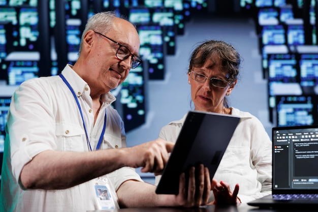 Free Photo cloud computing business executives running analysis on supercomputers used for managing databases, hosting websites and storing files. precise experts auditing high tech server hub components