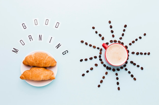 Free Photo coffee beans shape sun shape and croissants