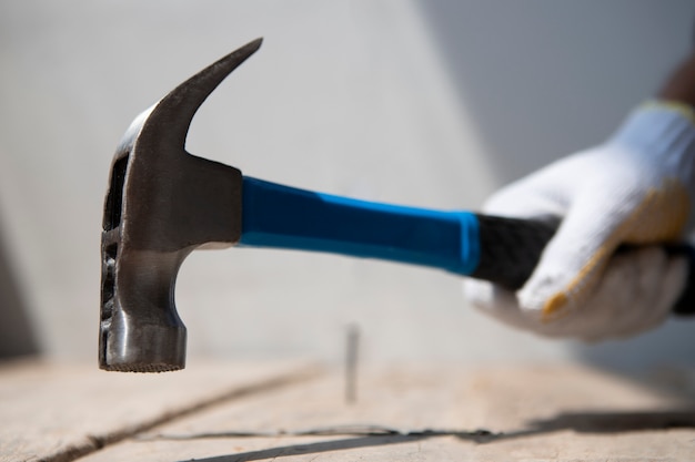Free Photo construction worker using hammer at job site