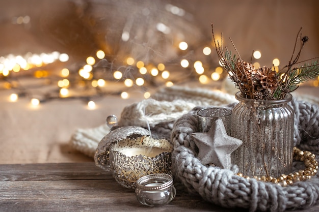 Free Photo cozy christmas composition with candles in a decorative candlestick. the concept of home comfort and warmth.