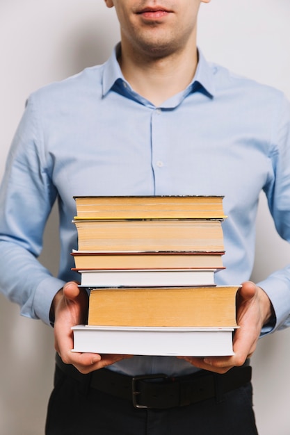 Free Photo crop man holding stack of books