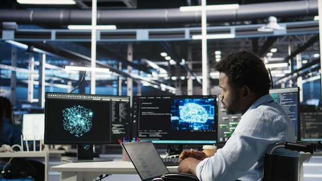 Free Photo data center computer scientist in wheelchair using ai node tree software