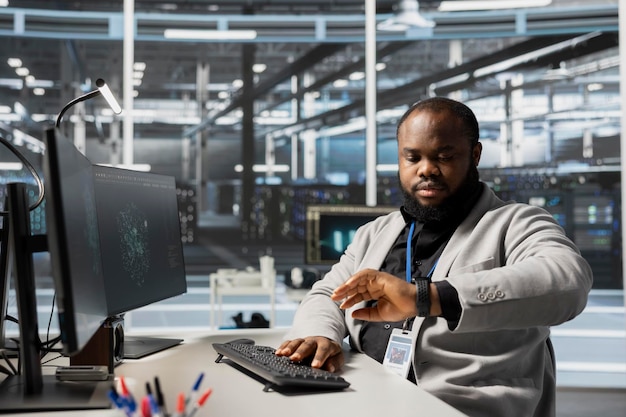 Free Photo data center engineer checking clock at work waiting for job shift to end
