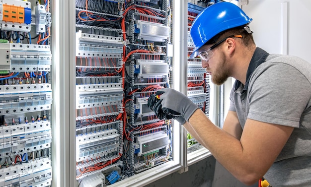 Free Photo electrician working in switchboard electrical component setup cable connection