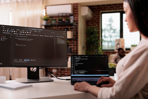 Free Photo female freelance developer coding html script with online cloud server and programming firewall security. learning new user interface on terminal window with code language and application.
