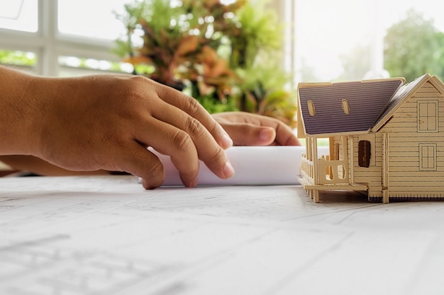 Free Photo hands of engineer working on blueprint,construction concept. engineering tools.vintage tone retro filter effect,soft focus(selective focus)