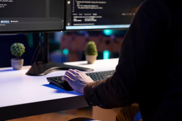 Free Photo it admin in apartment fixing coding issues typing on keyboard close up