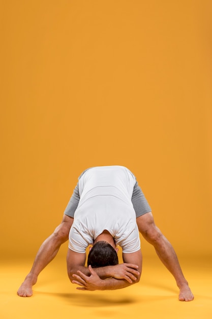 Free Photo man doing yoga exercise