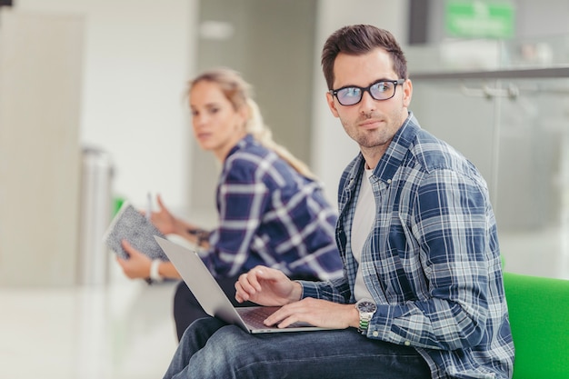 Free Photo man in glasses using laptop