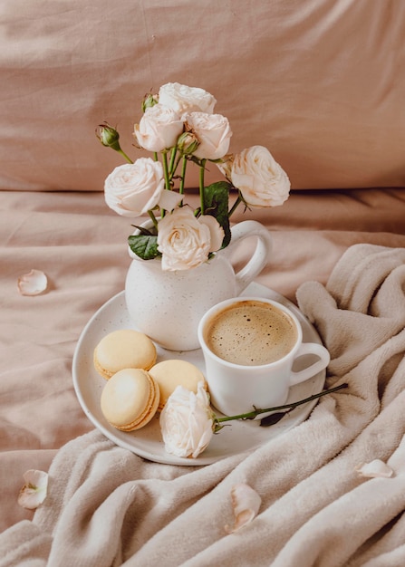 Free Photo morning coffee with macarons and flowers