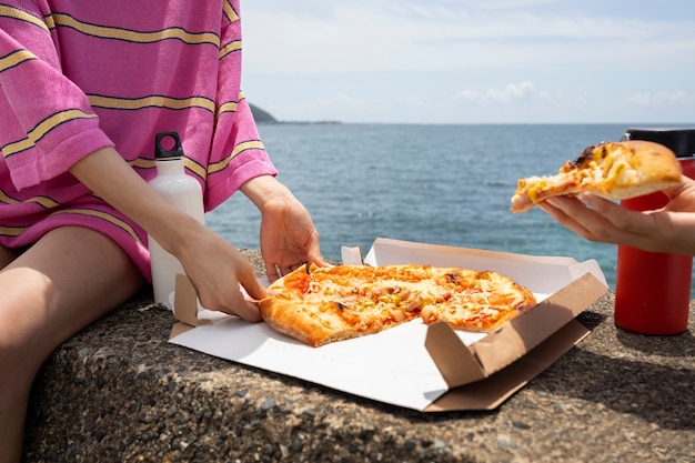 People enjoying a pizza snack outdoors
