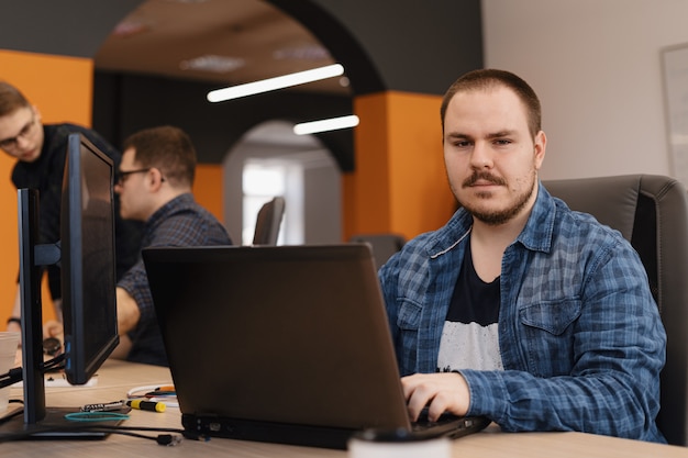 Free Photo programmer working on desktop pc programming code