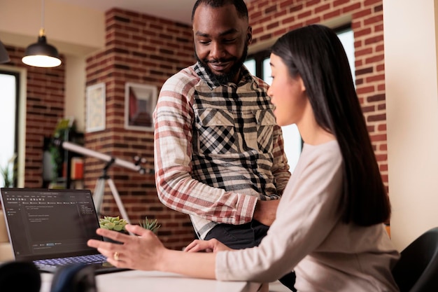 Free Photo programmers couple developing encryption code on laptop, using terminal window with html script and binary code. programming online application cloud server with firewall security.