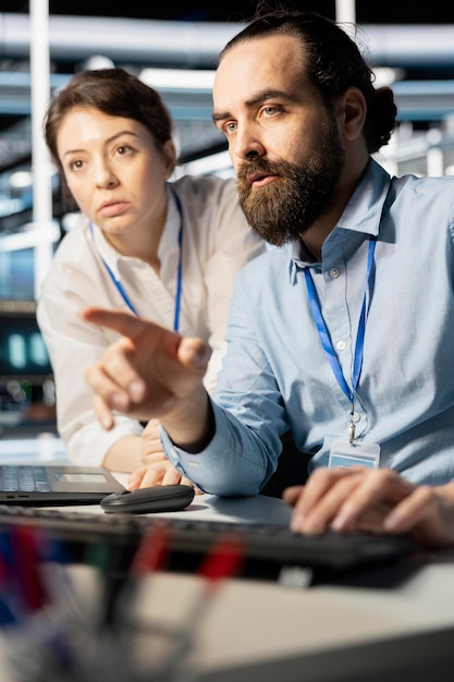 Free Photo programmers in data center workplace using computer verifying firewall