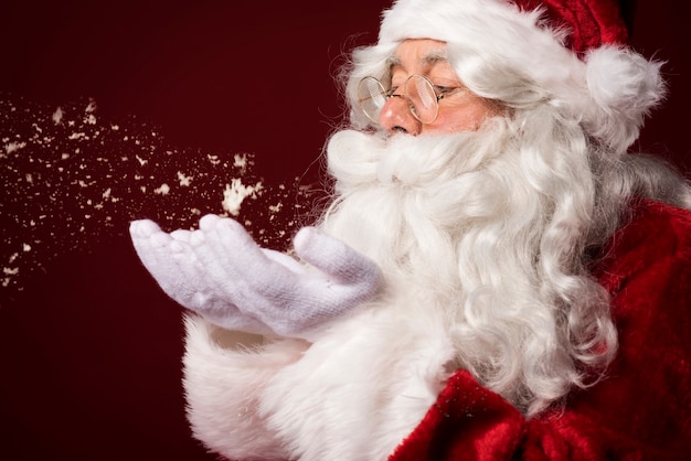 Free Photo santa claus blowing some snowflakes
