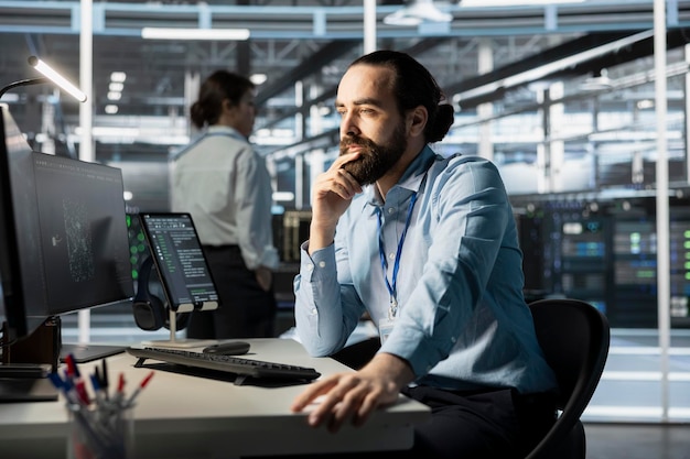 Free Photo system administrator using computer in data center running scripts