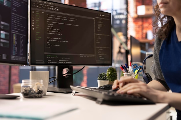Free Photo technician looking at ui on computer monitor and executing programming code