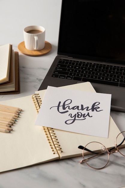 Free Photo thank you note, notebook and laptop