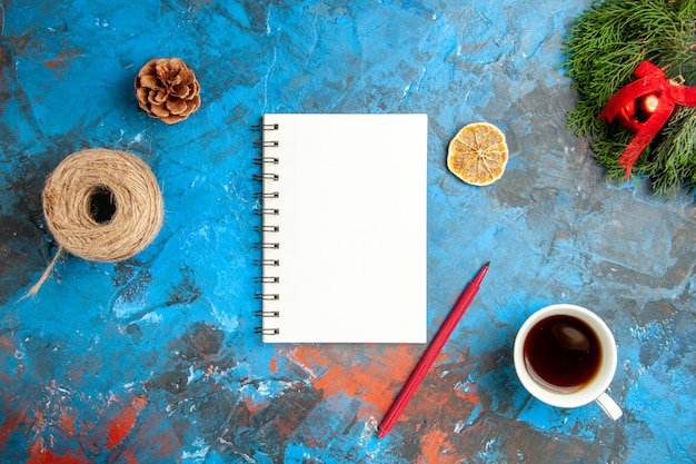 Free Photo top view cup of tea with notepad