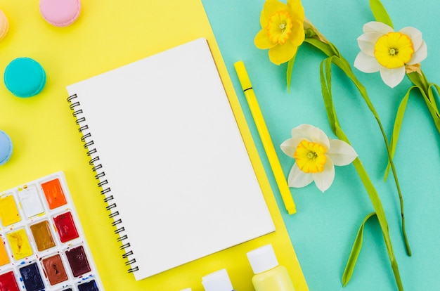 Free Photo top view notebook surrounded by painting elements