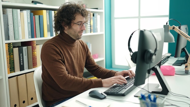 Free Photo young hispanic man student using computer studying at library university