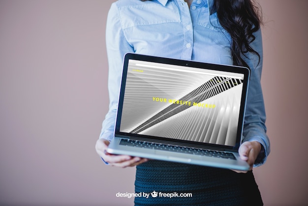 Free PSD businesswoman holding laptop
