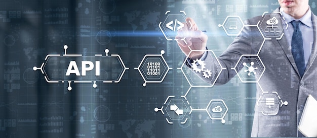 Photo application programming interface api software development tool information technology concept businessman presses api text icon on a virtual interface
