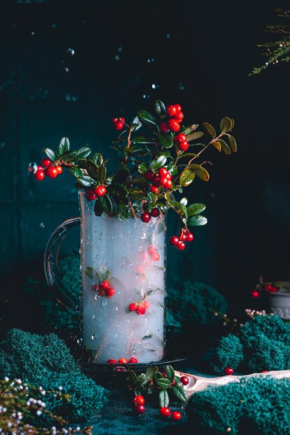 Photo bottle full of berries fresh ripe northern lingonberry  the concept of healthy food and organic