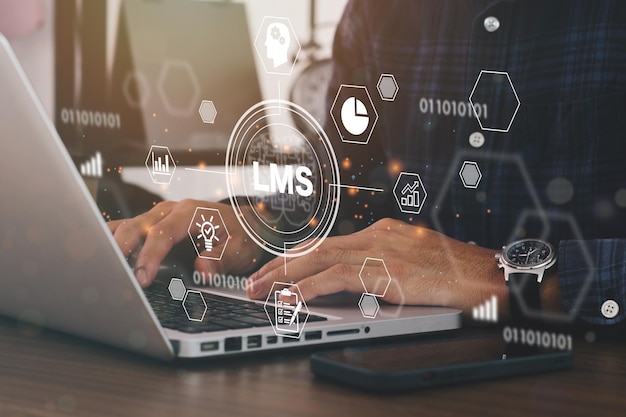 Photo businessman using a computer to lms - learning management system web icon for lesson and online education, course, application, study, e learning, knowledge everywhere and every time.