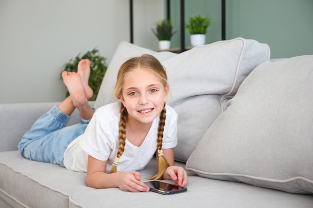 Photo child play with a mobile phone at home