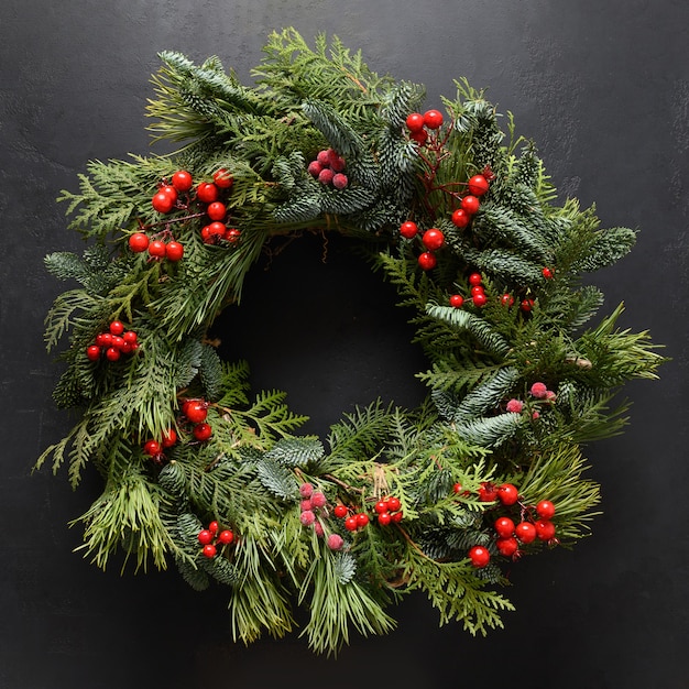 Photo christmas wreath of fresh natural spruce branch with red berries new year xmas holiday