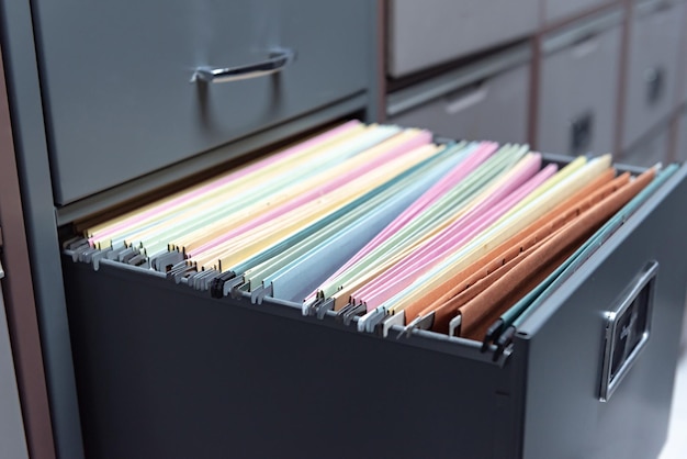 Photo close-up of multi colored envelopes in locker