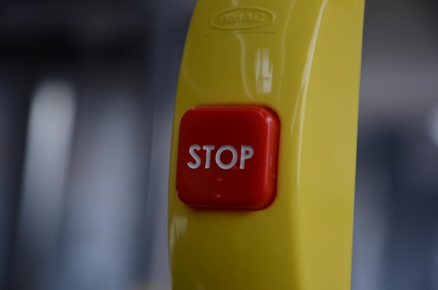 Photo close-up of stop button on handle in bus