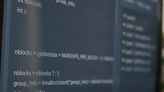 Photo closeup of computer screen of system engineer typing source code in it startup agency. display concept of software developer writing programming language. scrolling text of database functions script.