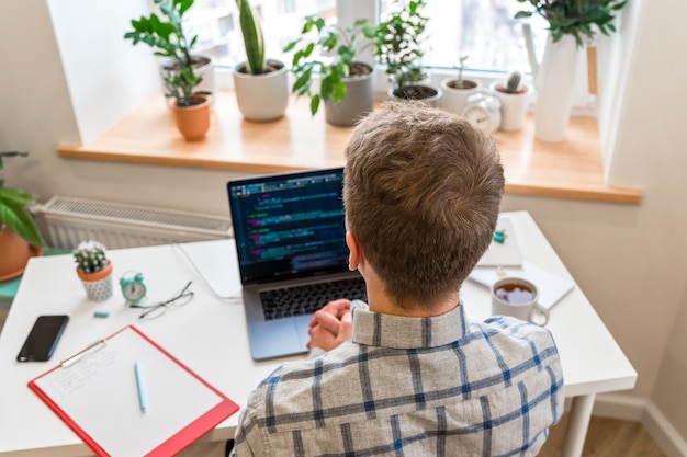 Photo coding on screen man's hands coding and programming on screen laptop development web developer