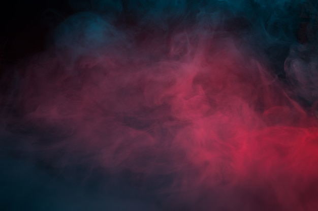 Photo colorful smoke on a black background closeup