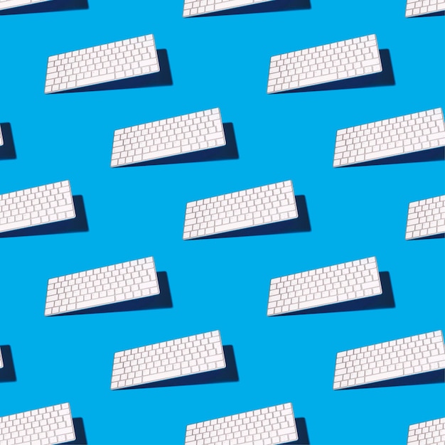 Photo computer keyboard on blue background with shadows seamless pattern