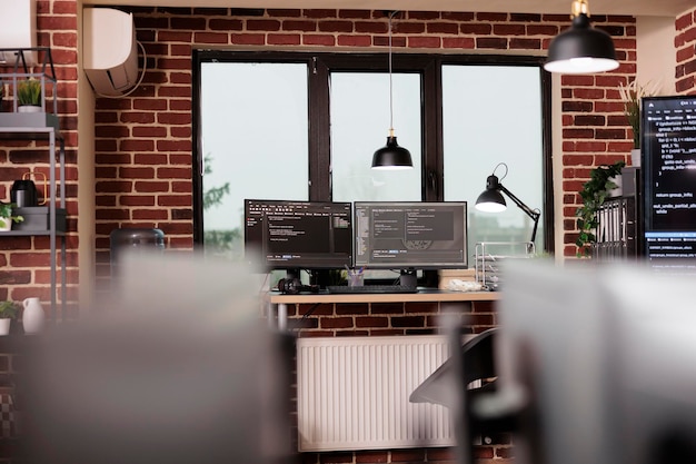 Photo desk table with multiple monitors running terminal window and artificial intelligence programming database script. empty it programming agency office with servers cloud computing. coding concept
