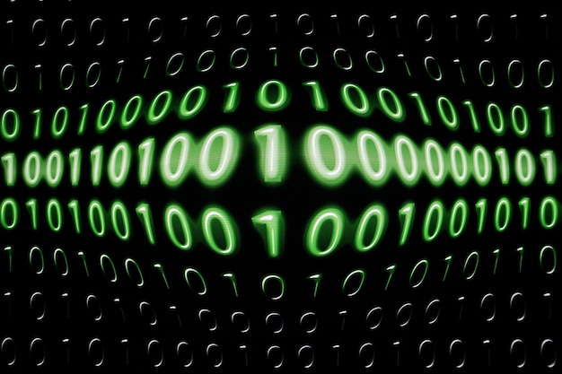Photo digital binary data and streaming binary code on computer screen