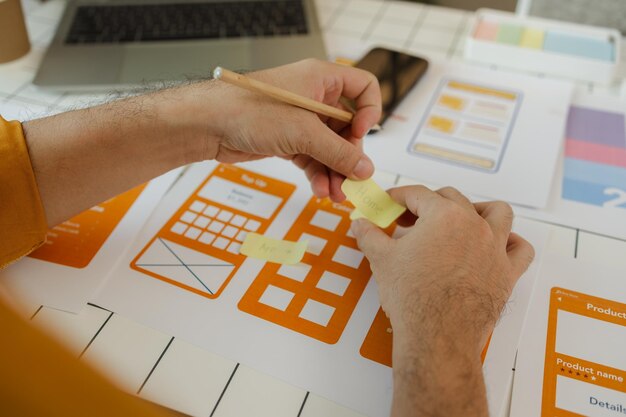 Photo a digital product developer is working on a plan to work with research data to guide the development of a website that is as effective as possible for users while also being visually appealing