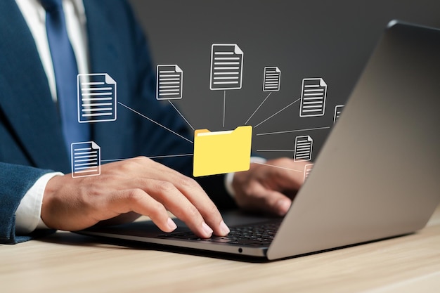 Photo document management system technology concept businessman using laptop with database on computer to store files document data digital file storage process with security and information technology