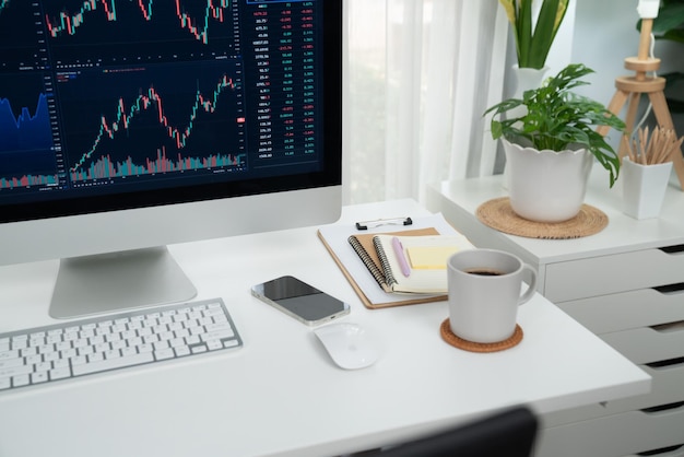 Photo dynamic stock exchange market's graph display on computer and laptop screen workspace with stock graph display for stock trader workspace with stock graph display for stock trader tastemaker