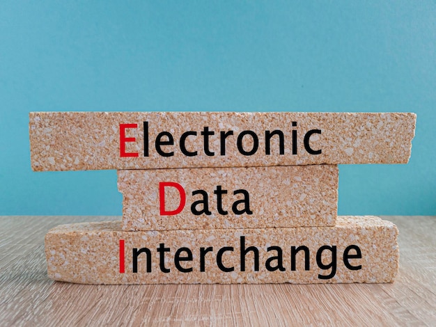 Photo edi electronic data interchange symbol concept words edi electronic data interchange on brick blocks