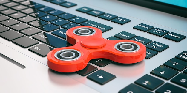 Photo fidget spinners on a computer keyboard 3d illustration