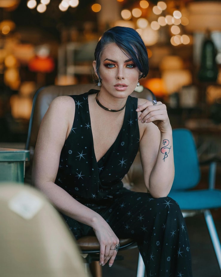 a green car with the hood up and the front bumper of it is a green car