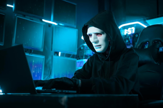 Photo a hacker is using laptop computer to steal data in the night