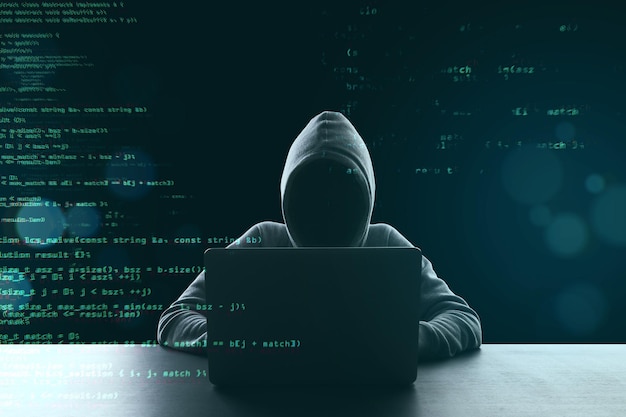 Photo hacker using laptop computer with html code