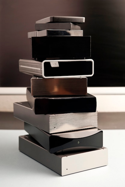 Photo hard drive stack different sizes and various colors with partial computer view and white background